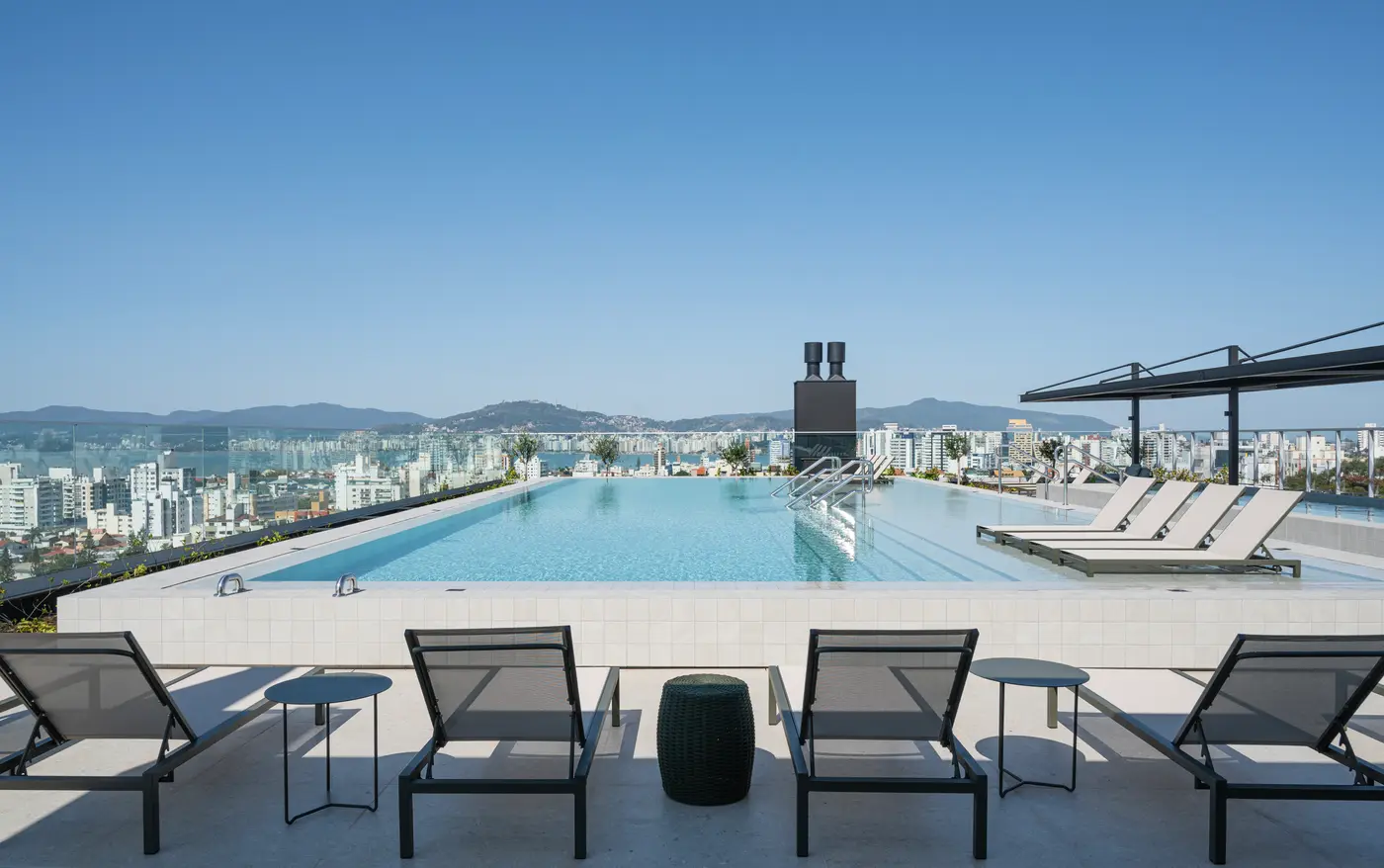 A piscina da cobertura, com a cidade ao fundo
